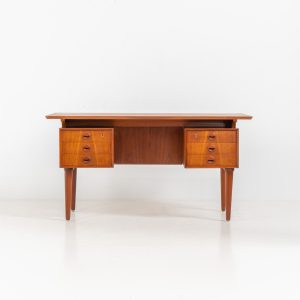 Large writing desk in the manner of Kai Kristiansen (Denmark, 1960s). A beautifully crafted freestanding writing desk, executed in the manner of Kai Kristiansen and dating to the 1960s. The design reflects the clean lines, refined proportions, and functional elegance characteristic of Danish modernism. The generously sized top offers ample workspace, making it ideal for both home and professional settings. The front features six spacious drawers, 2 with functional locks, providing practical and secure storage. The fully finished back includes additional storage compartments, allowing the desk to be positioned freely in the center of a room. The desk remains in very good condition, showing only minor age-related wear and light surface scratches consistent with its vintage character.