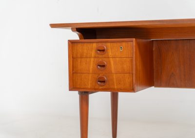 Large writing desk in the manner of Kai Kristiansen (Denmark, 1960s). A beautifully crafted freestanding writing desk, executed in the manner of Kai Kristiansen and dating to the 1960s. The design reflects the clean lines, refined proportions, and functional elegance characteristic of Danish modernism. The generously sized top offers ample workspace, making it ideal for both home and professional settings. The front features six spacious drawers, 2 with functional locks, providing practical and secure storage. The fully finished back includes additional storage compartments, allowing the desk to be positioned freely in the center of a room. The desk remains in very good condition, showing only minor age-related wear and light surface scratches consistent with its vintage character.