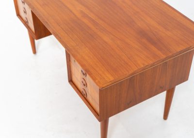 Large writing desk in the manner of Kai Kristiansen (Denmark, 1960s). A beautifully crafted freestanding writing desk, executed in the manner of Kai Kristiansen and dating to the 1960s. The design reflects the clean lines, refined proportions, and functional elegance characteristic of Danish modernism. The generously sized top offers ample workspace, making it ideal for both home and professional settings. The front features six spacious drawers, 2 with functional locks, providing practical and secure storage. The fully finished back includes additional storage compartments, allowing the desk to be positioned freely in the center of a room. The desk remains in very good condition, showing only minor age-related wear and light surface scratches consistent with its vintage character.