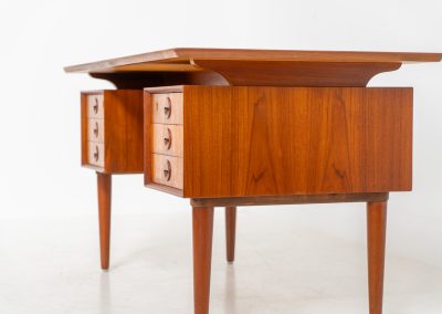 Large writing desk in the manner of Kai Kristiansen (Denmark, 1960s). A beautifully crafted freestanding writing desk, executed in the manner of Kai Kristiansen and dating to the 1960s. The design reflects the clean lines, refined proportions, and functional elegance characteristic of Danish modernism. The generously sized top offers ample workspace, making it ideal for both home and professional settings. The front features six spacious drawers, 2 with functional locks, providing practical and secure storage. The fully finished back includes additional storage compartments, allowing the desk to be positioned freely in the center of a room. The desk remains in very good condition, showing only minor age-related wear and light surface scratches consistent with its vintage character.