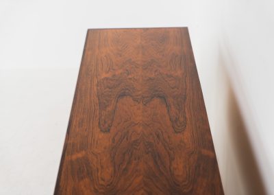 Extremely rare sideboard in rosewood by Svend Aage Larsen for Faarup (Denmark, 1950s). A rare and refined sideboard designed by Svend Aage Larsen and produced by Faarup in the 1950s. The façade is defined by two elegantly crafted tambour sliding doors, complemented by four drawers with beautifully inset handles. The interior layout offers generous and well-organized storage. Executed in richly figured Brazilian rosewood, the cabinet displays a deep and dynamic grain pattern, highlighting the exceptional timber selection and craftsmanship of the period. The piece presents in excellent vintage condition, with only minor age-related wear consistent with its history.