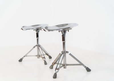 Rare pair of Dulton stools by Yasu Satamoto for Dulton Co. (Japan, 1970s). A striking and unconventional pair of chrome stools designed by experimental Japanese designer Yasu Satamoto for Dulton Co. The concept is both playful and industrial: a sculptural tractor seat mounted onto a drummer’s stool base, executed in stainless steel. The stools are easily foldable and collapsible, making them practical as well as visually distinctive. They remain in good vintage condition, showing a beautiful patina with light, age-related rust marks. We have chosen to preserve this finish to enhance their authentic character, but they can of course be polished and the rust removed upon request.
