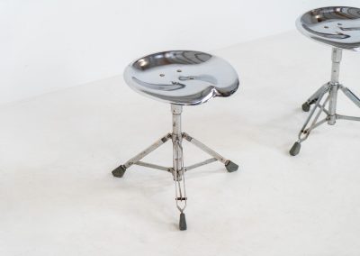 Rare pair of Dulton stools by Yasu Satamoto for Dulton Co. (Japan, 1970s). A striking and unconventional pair of chrome stools designed by experimental Japanese designer Yasu Satamoto for Dulton Co. The concept is both playful and industrial: a sculptural tractor seat mounted onto a drummer’s stool base, executed in stainless steel. The stools are easily foldable and collapsible, making them practical as well as visually distinctive. They remain in good vintage condition, showing a beautiful patina with light, age-related rust marks. We have chosen to preserve this finish to enhance their authentic character, but they can of course be polished and the rust removed upon request.