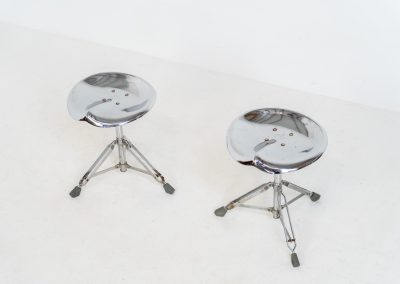 Rare pair of Dulton stools by Yasu Satamoto for Dulton Co. (Japan, 1970s). A striking and unconventional pair of chrome stools designed by experimental Japanese designer Yasu Satamoto for Dulton Co. The concept is both playful and industrial: a sculptural tractor seat mounted onto a drummer’s stool base, executed in stainless steel. The stools are easily foldable and collapsible, making them practical as well as visually distinctive. They remain in good vintage condition, showing a beautiful patina with light, age-related rust marks. We have chosen to preserve this finish to enhance their authentic character, but they can of course be polished and the rust removed upon request.