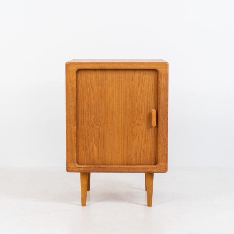 Compact cabinet with tambour door by CFC Silkeborg (Denmark, 1960s). The cabinet is made out of teak and features stunning organic shapes and lots of amazing details, like the tambour door and the rounded handle. The shelve on the inside is adjustable. A perfect piece to use for a record player and vinyls! This piece presents itself in very good condition with no damages, the top has a little discoloration.