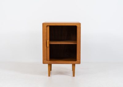 Compact cabinet with tambour door by CFC Silkeborg (Denmark, 1960s). The cabinet is made out of teak and features stunning organic shapes and lots of amazing details, like the tambour door and the rounded handle. The shelve on the inside is adjustable. A perfect piece to use for a record player and vinyls! This piece presents itself in very good condition with no damages, the top has a little discoloration.