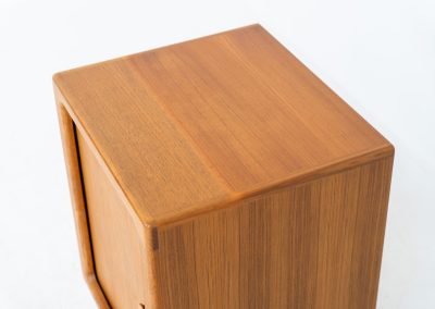 Compact cabinet with tambour door by CFC Silkeborg (Denmark, 1960s). The cabinet is made out of teak and features stunning organic shapes and lots of amazing details, like the tambour door and the rounded handle. The shelve on the inside is adjustable. A perfect piece to use for a record player and vinyls! This piece presents itself in very good condition with no damages, the top has a little discoloration.