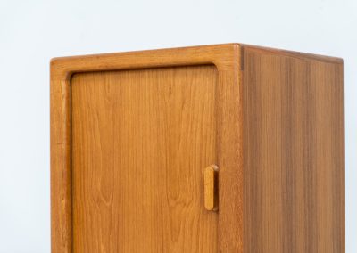 Compact cabinet with tambour door by CFC Silkeborg (Denmark, 1960s). The cabinet is made out of teak and features stunning organic shapes and lots of amazing details, like the tambour door and the rounded handle. The shelve on the inside is adjustable. A perfect piece to use for a record player and vinyls! This piece presents itself in very good condition with no damages, the top has a little discoloration.