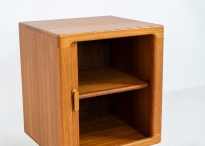 Compact cabinet with tambour door by CFC Silkeborg (Denmark, 1960s). The cabinet is made out of teak and features stunning organic shapes and lots of amazing details, like the tambour door and the rounded handle. The shelve on the inside is adjustable. A perfect piece to use for a record player and vinyls! This piece presents itself in very good condition with no damages, the top has a little discoloration.