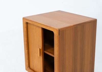 Compact cabinet with tambour door by CFC Silkeborg (Denmark, 1960s). The cabinet is made out of teak and features stunning organic shapes and lots of amazing details, like the tambour door and the rounded handle. The shelve on the inside is adjustable. A perfect piece to use for a record player and vinyls! This piece presents itself in very good condition with no damages, the top has a little discoloration.