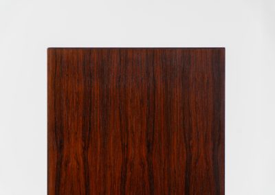 Rosewood bookcase by Aejm Møbler (Denmark, 1960s). Minimalist Danish bookcase crafted in richly grained rosewood. The design is clean and architectural, with well-balanced proportions and a strong vertical rhythm. The cabinet features fixed shelves and four integrated record dividers, making it ideal for vinyl storage while still offering versatile display space. A well-built and functional piece with the original maker's label intact. Presented in good vintage condition with only light, age-appropriate wear.