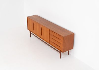 “RT200” sideboard by Heinrich Riestenpatt (Germany, 1960s). A very elegant sideboard by German designer Heinrich Riestenpatt, executed in warm teak. The clean, architectural form is complemented by stunning organic handles and beautifully balanced proportions. A distinctive feature of this piece is the set of sculpted, slightly stepped drawers, offering both visual rhythm and practical storage. Three doors reveal generous interior space, making the sideboard as functional as it is refined. A timeless example of German modern design, presented in excellent vintage condition.
