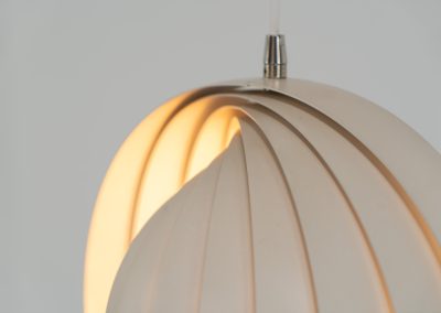 A wonderful example of an early “Moon” pendant light by Verner Panton for Louis Poulsen (Denmark, 1960s). An early model of the iconic Space Age "moon lamp," also known as the Visor pendant, designed by Verner Panton in the 1960s and produced by Louis Poulsen, Denmark. This sculptural piece features ten white, rotatable rings made of enameled metal, arranged around a central light source. The adjustable blades allow for subtle variation in light diffusion, creating a warm, atmospheric glow while maintaining its striking geometric presence. A true Danish Op-Art design classic, the lamp combines functionality with a bold visual identity that remains timeless. The lamp is in very good vintage condition with some minor scuffs in the paint.