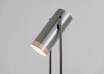Trombone floorlamp by Jo Hammerborg for Fog & Mørup (Denmark, 1960s). This stunning lamp is made out of a square metal base, 2 chrome rods and a tubular aluminium shade perforated with elongated slots on top and below. This one is an early production in good vintage condition with visible using traces on and inside the shade.