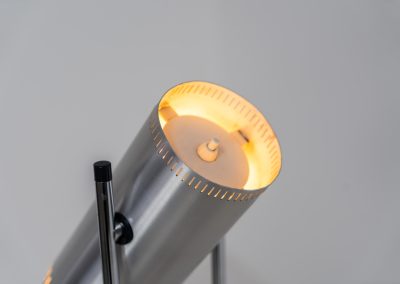 Trombone floorlamp by Jo Hammerborg for Fog & Mørup (Denmark, 1960s). This stunning lamp is made out of a square metal base, 2 chrome rods and a tubular aluminium shade perforated with elongated slots on top and below. This one is an early production in good vintage condition with visible using traces on and inside the shade.