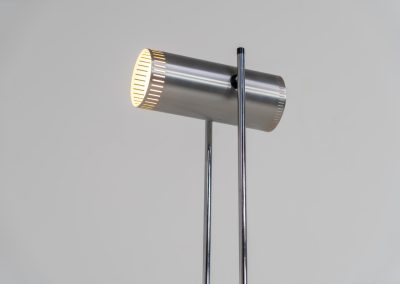 Trombone floorlamp by Jo Hammerborg for Fog & Mørup (Denmark, 1960s). This stunning lamp is made out of a square metal base, 2 chrome rods and a tubular aluminium shade perforated with elongated slots on top and below. This one is an early production in good vintage condition with visible using traces on and inside the shade.