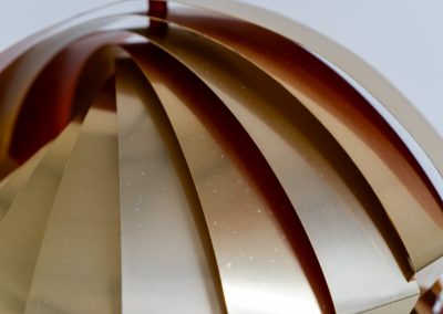 “Konkylie” pendant light by Louis Weisdorf for Lyfa (Denmark, 1960s). A strong, sculptural design with a clear architectural feel, typical of Weisdorf’s work. The layered brass shades unfold like a shell, revealing a striking red and orange interior that adds depth and warmth. When lit, the light is softly diffused, creating a rich, atmospheric glow with subtle color reflection. The interplay between the polished brass exterior and the warm-toned interior gives the piece a dynamic character. A well-balanced design that works just as well as a statement piece above a dining table as it does in a more minimal setting. A solid example of Danish mid-century lighting, where form and function meet effortlessly.