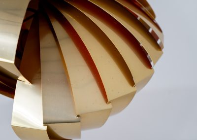 “Konkylie” pendant light by Louis Weisdorf for Lyfa (Denmark, 1960s). A strong, sculptural design with a clear architectural feel, typical of Weisdorf’s work. The layered brass shades unfold like a shell, revealing a striking red and orange interior that adds depth and warmth. When lit, the light is softly diffused, creating a rich, atmospheric glow with subtle color reflection. The interplay between the polished brass exterior and the warm-toned interior gives the piece a dynamic character. A well-balanced design that works just as well as a statement piece above a dining table as it does in a more minimal setting. A solid example of Danish mid-century lighting, where form and function meet effortlessly.