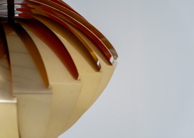 “Konkylie” pendant light by Louis Weisdorf for Lyfa (Denmark, 1960s). A strong, sculptural design with a clear architectural feel, typical of Weisdorf’s work. The layered brass shades unfold like a shell, revealing a striking red and orange interior that adds depth and warmth. When lit, the light is softly diffused, creating a rich, atmospheric glow with subtle color reflection. The interplay between the polished brass exterior and the warm-toned interior gives the piece a dynamic character. A well-balanced design that works just as well as a statement piece above a dining table as it does in a more minimal setting. A solid example of Danish mid-century lighting, where form and function meet effortlessly.