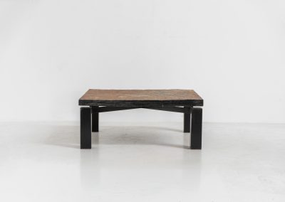 Brutalist Coffee Table in Norwegian Slate stone, 1970s A very powerful Brutalist coffee table from the 1970s, defined by its strong architectural presence and sculptural simplicity. The substantial tabletop is crafted from Norwegian slate, showcasing a rich and varied surface with natural tonal shifts that create depth and visual texture. The solid stone top is supported by a black lacquered metal base, offering a bold contrast while reinforcing the table’s grounded and monolithic character. The table remains in very good condition, with light, age-appropriate wear such as minor scratches to the frame.