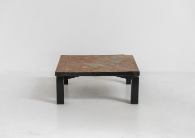 Brutalist Coffee Table in Norwegian Slate stone, 1970s A very powerful Brutalist coffee table from the 1970s, defined by its strong architectural presence and sculptural simplicity. The substantial tabletop is crafted from Norwegian slate, showcasing a rich and varied surface with natural tonal shifts that create depth and visual texture. The solid stone top is supported by a black lacquered metal base, offering a bold contrast while reinforcing the table’s grounded and monolithic character. The table remains in very good condition, with light, age-appropriate wear such as minor scratches to the frame.