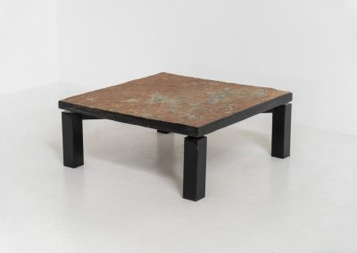 Brutalist Coffee Table in Norwegian Slate stone, 1970s A very powerful Brutalist coffee table from the 1970s, defined by its strong architectural presence and sculptural simplicity. The substantial tabletop is crafted from Norwegian slate, showcasing a rich and varied surface with natural tonal shifts that create depth and visual texture. The solid stone top is supported by a black lacquered metal base, offering a bold contrast while reinforcing the table’s grounded and monolithic character. The table remains in very good condition, with light, age-appropriate wear such as minor scratches to the frame.