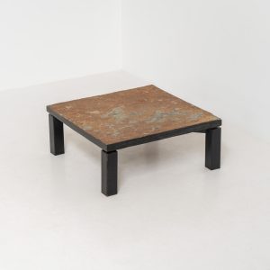 Brutalist Coffee Table in Norwegian Slate stone, 1970s A very powerful Brutalist coffee table from the 1970s, defined by its strong architectural presence and sculptural simplicity. The substantial tabletop is crafted from Norwegian slate, showcasing a rich and varied surface with natural tonal shifts that create depth and visual texture. The solid stone top is supported by a black lacquered metal base, offering a bold contrast while reinforcing the table’s grounded and monolithic character. The table remains in very good condition, with light, age-appropriate wear such as minor scratches to the frame.