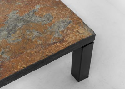 Brutalist Coffee Table in Norwegian Slate stone, 1970s A very powerful Brutalist coffee table from the 1970s, defined by its strong architectural presence and sculptural simplicity. The substantial tabletop is crafted from Norwegian slate, showcasing a rich and varied surface with natural tonal shifts that create depth and visual texture. The solid stone top is supported by a black lacquered metal base, offering a bold contrast while reinforcing the table’s grounded and monolithic character. The table remains in very good condition, with light, age-appropriate wear such as minor scratches to the frame.