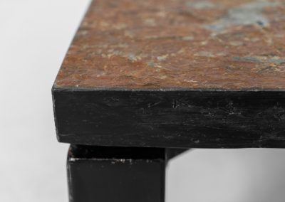 Brutalist Coffee Table in Norwegian Slate stone, 1970s A very powerful Brutalist coffee table from the 1970s, defined by its strong architectural presence and sculptural simplicity. The substantial tabletop is crafted from Norwegian slate, showcasing a rich and varied surface with natural tonal shifts that create depth and visual texture. The solid stone top is supported by a black lacquered metal base, offering a bold contrast while reinforcing the table’s grounded and monolithic character. The table remains in very good condition, with light, age-appropriate wear such as minor scratches to the frame.