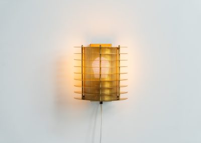 Wall light by Borens (Sweden, 1980s). A refined example of Scandinavian modernism, this wall lamp features layered metal shades surrounding a perforated inner cylinder, creating a warm, diffused glow. The structured, almost architectural design adds depth while maintaining a clean and balanced aesthetic. In very good vintage condition with a mild patina to the metal. Marked by maker.