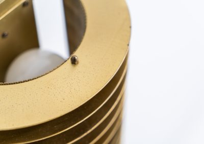 Wall light by Borens (Sweden, 1980s). A refined example of Scandinavian modernism, this wall lamp features layered metal shades surrounding a perforated inner cylinder, creating a warm, diffused glow. The structured, almost architectural design adds depth while maintaining a clean and balanced aesthetic. In very good vintage condition with a mild patina to the metal. Marked by maker.