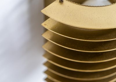 Wall light by Borens (Sweden, 1980s). A refined example of Scandinavian modernism, this wall lamp features layered metal shades surrounding a perforated inner cylinder, creating a warm, diffused glow. The structured, almost architectural design adds depth while maintaining a clean and balanced aesthetic. In very good vintage condition with a mild patina to the metal. Marked by maker.