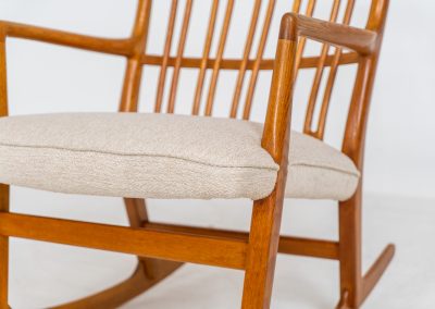 A rare “ML33” rocking chair by Hans J. Wegner for A. Mikael Laursen (Denmark, 1950s). Pure Danish craftsmanship from the 1950s, featuring a highly sculptural silhouette crafted from solid oak. A true masterpiece of mid-century design. The chair has been reupholstered in a beautifully textured of-white fabric and contains new straps.