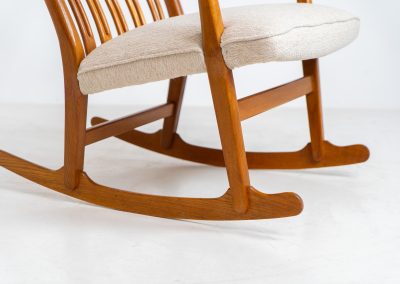 A rare “ML33” rocking chair by Hans J. Wegner for A. Mikael Laursen (Denmark, 1950s). Pure Danish craftsmanship from the 1950s, featuring a highly sculptural silhouette crafted from solid oak. A true masterpiece of mid-century design. The chair has been reupholstered in a beautifully textured of-white fabric and contains new straps.