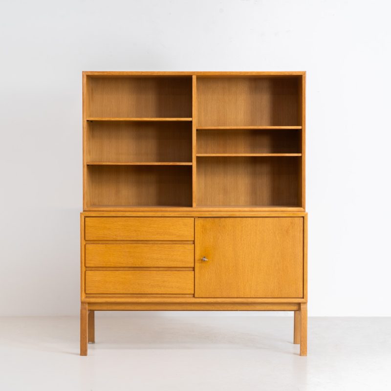 Bookcase by Marianne Grabinski for Ikea (Sweden, 1960s). This two-piece bookcase was designed by Marianne Grabinski for IKEA, back when the company was still exclusively based in Sweden. It is crafted from oak and offers generous storage space, featuring four adjustable shelves, three drawers, and a cabinet with a functional lock. The bookcase is in very good condition, showing only minor signs of age and use.
