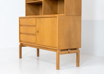 Bookcase by Marianne Grabinski for Ikea (Sweden, 1960s). This two-piece bookcase was designed by Marianne Grabinski for IKEA, back when the company was still exclusively based in Sweden. It is crafted from oak and offers generous storage space, featuring four adjustable shelves, three drawers, and a cabinet with a functional lock. The bookcase is in very good condition, showing only minor signs of age and use.