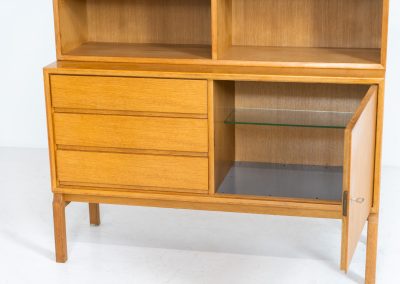 Bookcase by Marianne Grabinski for Ikea (Sweden, 1960s). This two-piece bookcase was designed by Marianne Grabinski for IKEA, back when the company was still exclusively based in Sweden. It is crafted from oak and offers generous storage space, featuring four adjustable shelves, three drawers, and a cabinet with a functional lock. The bookcase is in very good condition, showing only minor signs of age and use.