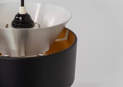 Stunning pendant light by Carl Thore for Granhaga (Sweden, 1960s). A sleek design featuring two aluminium shades and a black halo which is lacquered in yellow on the inside. The yellow interior creates a beautiful defused and moody light dispersion. The lamp remains in very good condition.