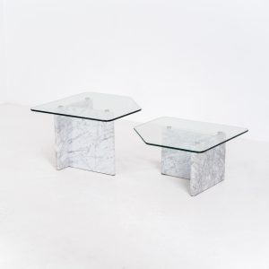 Marble & glass coffee tables (Italy, 1970s). A striking pair of coffee tables that perfectly balance weight and lightness. Each piece features a sculptural marble base with elegant veining, contrasted by a floating glass top that enhances the clean, architectural lines. The asymmetrical forms give the set a playful yet refined presence, making them ideal as a duo or used separately. Both tables are in very good condition.