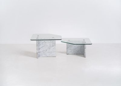 Marble & glass coffee tables (Italy, 1970s). A striking pair of coffee tables that perfectly balance weight and lightness. Each piece features a sculptural marble base with elegant veining, contrasted by a floating glass top that enhances the clean, architectural lines. The asymmetrical forms give the set a playful yet refined presence, making them ideal as a duo or used separately. Both tables are in very good condition.