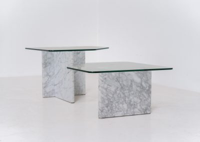 Marble & glass coffee tables (Italy, 1970s). A striking pair of coffee tables that perfectly balance weight and lightness. Each piece features a sculptural marble base with elegant veining, contrasted by a floating glass top that enhances the clean, architectural lines. The asymmetrical forms give the set a playful yet refined presence, making them ideal as a duo or used separately. Both tables are in very good condition.