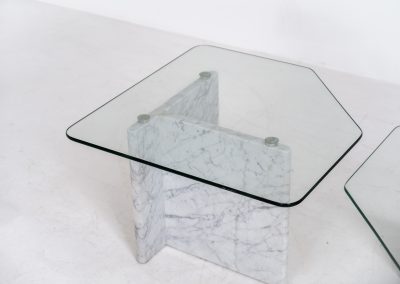 Marble & glass coffee tables (Italy, 1970s). A striking pair of coffee tables that perfectly balance weight and lightness. Each piece features a sculptural marble base with elegant veining, contrasted by a floating glass top that enhances the clean, architectural lines. The asymmetrical forms give the set a playful yet refined presence, making them ideal as a duo or used separately. Both tables are in very good condition.