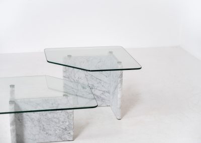 Marble & glass coffee tables (Italy, 1970s). A striking pair of coffee tables that perfectly balance weight and lightness. Each piece features a sculptural marble base with elegant veining, contrasted by a floating glass top that enhances the clean, architectural lines. The asymmetrical forms give the set a playful yet refined presence, making them ideal as a duo or used separately. Both tables are in very good condition.