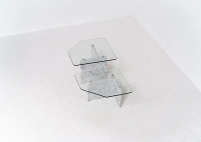 Marble & glass coffee tables (Italy, 1970s). A striking pair of coffee tables that perfectly balance weight and lightness. Each piece features a sculptural marble base with elegant veining, contrasted by a floating glass top that enhances the clean, architectural lines. The asymmetrical forms give the set a playful yet refined presence, making them ideal as a duo or used separately. Both tables are in very good condition.