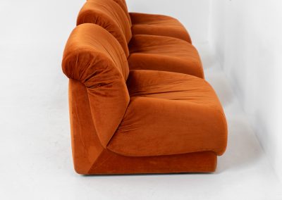 Modular sofa by Doimo Salotti (Italy, 1970s). Striking and bold modular seating system consisting of three identical elements and one corner piece, upholstered in their original vivid orange velvet. Can be arranged as a sofa or used as individual lounge chairs. Low, sculptural design with generous padding, offering both strong visual impact and excellent comfort. Professionally deep-cleaned and in very good original condition, with minor age-related wear. Some cracks to the underside dust covers (purely cosmetic, no impact on use or structure). Marked by maker.