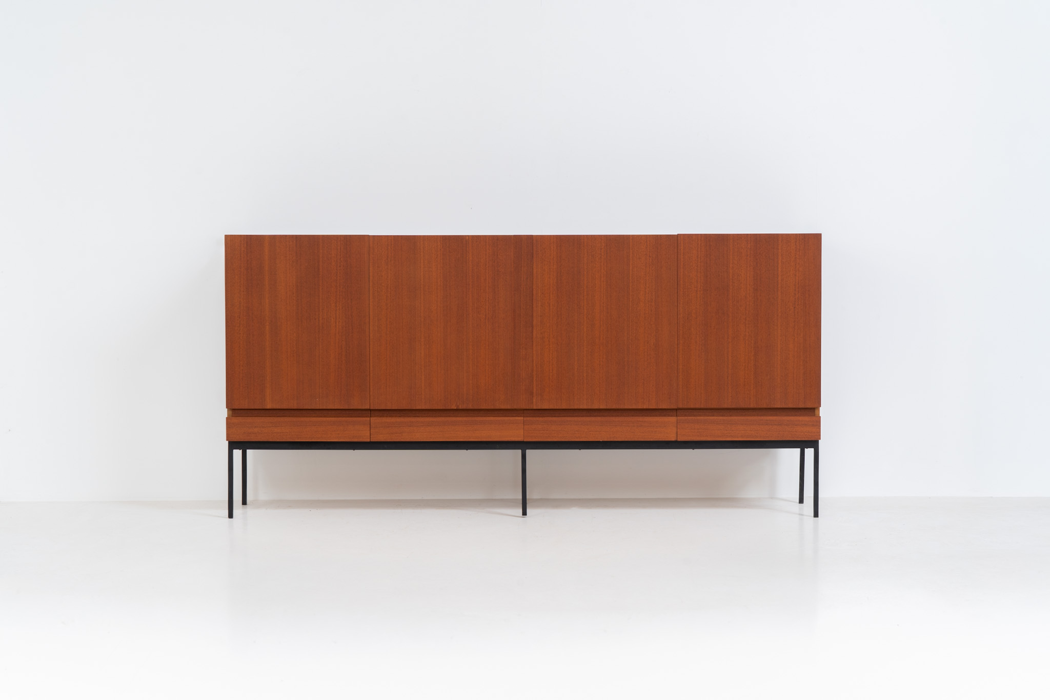 Iconic B60 sideboard by Dieter Waeckerlin for Behr (Germany, 1950s). This highly sought after and significant “B60” sideboard is a masterful blend of minimalistic design and functional elegance. It’s unbelievable this piece was made in the 50’s and is yet so timeless. It contains four drawers and four doors with a minimal gap between them. The inside offers lots of storage space with adjustable shelves. It is in amazing condition with minor sings of use and age.