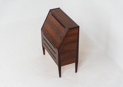 “No. 63” secretary by Kai Kristiansen for Torring Møbelfabrik (Denmark, 1960s). This very hard to find piece is one of our favorite secretaries and an example of high quality Danish craftsmanship. It features stunning aesthetics and nifty details like the sculptural handles or the convenient pivoting drop-down leaf. This particular piece is crafted out of rosewood and has an extraordinary woodgrain! It is in splendid condition with a minor repair mark on the lowest drawer.