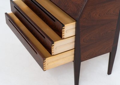 “No. 63” secretary by Kai Kristiansen for Torring Møbelfabrik (Denmark, 1960s). This very hard to find piece is one of our favorite secretaries and an example of high quality Danish craftsmanship. It features stunning aesthetics and nifty details like the sculptural handles or the convenient pivoting drop-down leaf. This particular piece is crafted out of rosewood and has an extraordinary woodgrain! It is in splendid condition with a minor repair mark on the lowest drawer.