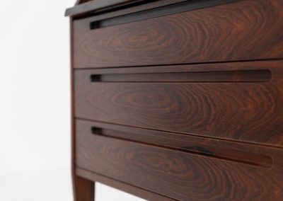“No. 63” secretary by Kai Kristiansen for Torring Møbelfabrik (Denmark, 1960s). This very hard to find piece is one of our favorite secretaries and an example of high quality Danish craftsmanship. It features stunning aesthetics and nifty details like the sculptural handles or the convenient pivoting drop-down leaf. This particular piece is crafted out of rosewood and has an extraordinary woodgrain! It is in splendid condition with a minor repair mark on the lowest drawer.