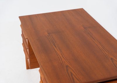 Teak writing desk by Arne Vodder for G.V. Møbler (Denmark, 1960s). This exceptionally beautiful piece is a true example of top-quality Danish craftsmanship. Made from teak, it showcases elegant aesthetics with softly rounded edges and a floating desk top. It contains six very deep drawers and a finished backside, making it an ideal piece for placement in the center of a room. The desk is in excellent condition.